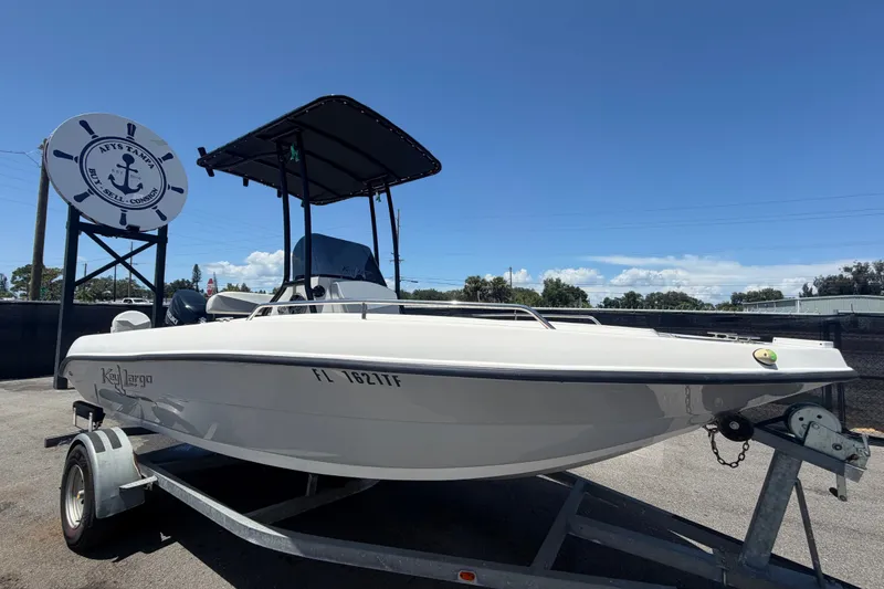 The Image of 2022 Key Largo 180 Center Console boat on trailer under clear blue sky. - 0