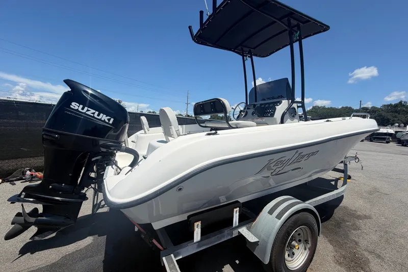 Slide: The Image of 2022 Key Largo 180 Center Console boat with Suzuki outboard motor on trailer. - 2