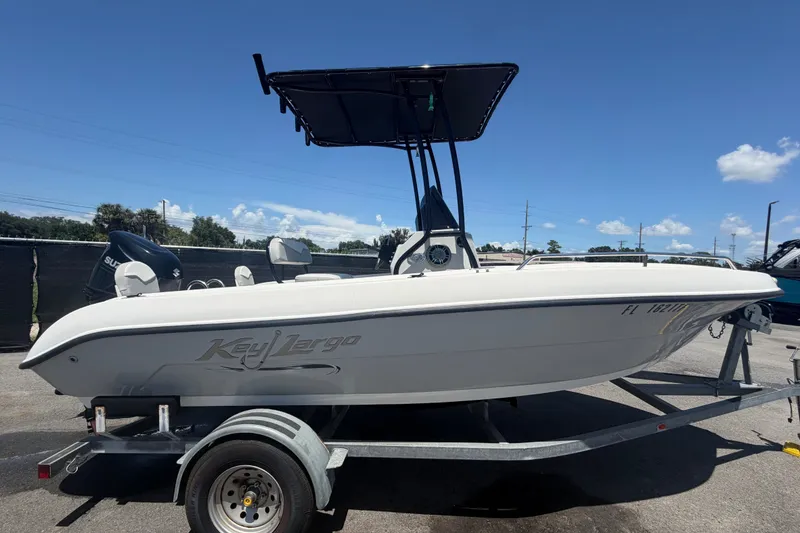 Slide: The Image of 2022 Key Largo 180 Center Console boat on trailer under clear blue sky. - 1