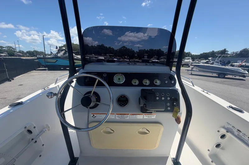 Slide: The Image of 2022 Key Largo 180 Center Console boat dashboard with steering wheel and controls. - 15
