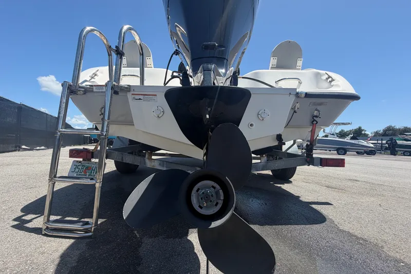 Slide: The Image of 2022 Key Largo 180 Center Console boat on trailer, rear view with propeller and ladder. - 4