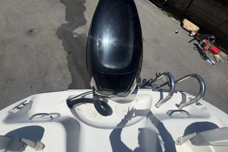 Slide: The Image of 2022 Key Largo 180 Center Console boat with outboard motor and ladder, viewed from above. - 49