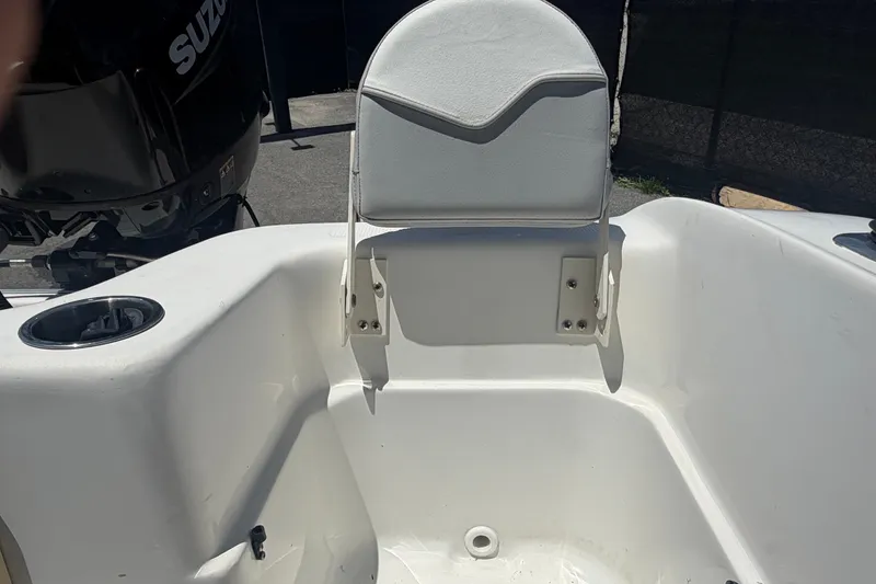 Slide: The Image of 2022 Key Largo 180 Center Console boat interior with seating and Suzuki engine. - 46