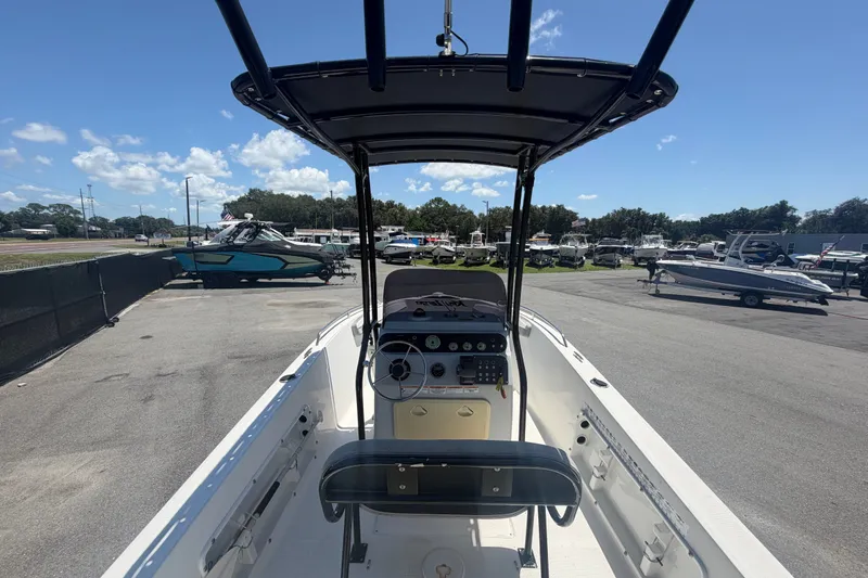 Slide: The Image of 2022 Key Largo 180 Center Console boat in a marina, showcasing helm and seating area. - 10