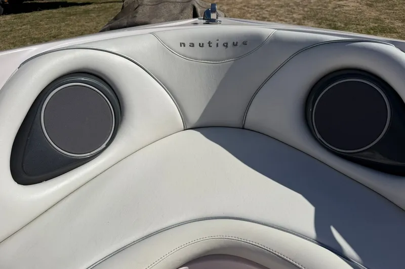 Slide: The Image of 2003 Nautique Air Nautique 226 boat interior with speakers and logo. - 49