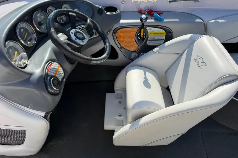 Slide: The Image of 2003 Nautique Air Nautique 226 boat interior with steering wheel and dashboard controls. - 39