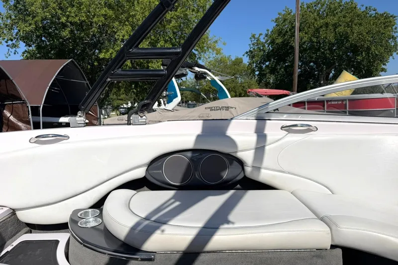 Slide: The Image of Interior of a 2003 Nautique Air Nautique 226 boat with white seating and cup holders. - 32
