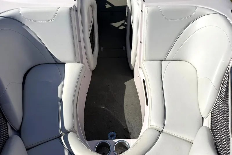 Slide: The Image of Interior seating of a 2003 Nautique Air Nautique 226 boat, featuring white upholstery. - 50