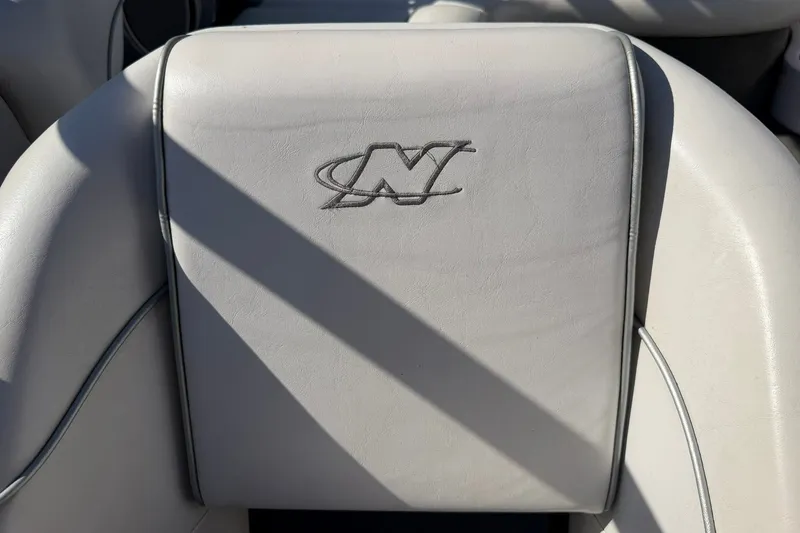 Slide: The Image of 2003 Nautique Air Nautique 226 boat seat with embroidered logo, featuring white upholstery. - 40
