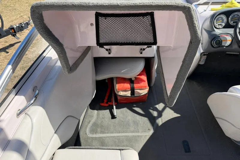 Slide: The Image of 2003 Nautique Air Nautique 226 interior with storage compartment and dashboard view. - 36