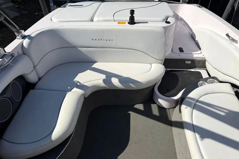 Slide: The Image of 2003 Nautique Air Nautique 226 boat interior with white cushioned seating and cup holders. - 27