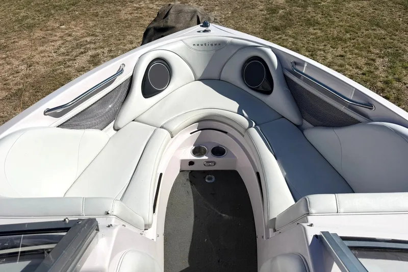 Slide: The Image of 2003 Nautique Air Nautique 226 boat interior with white seating and speaker system. - 44