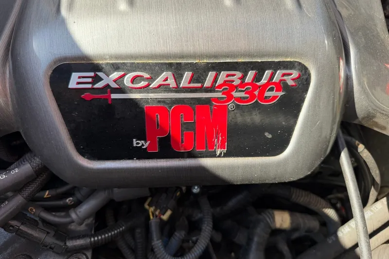Slide: The Image of Engine cover of a 2003 Nautique Air Nautique 226, featuring PCM Excalibur 330 branding. - 43
