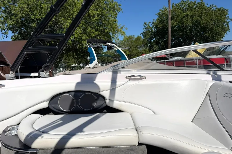 Slide: The Image of 2003 Nautique Air Nautique 226 interior with white seating and sleek design. - 33