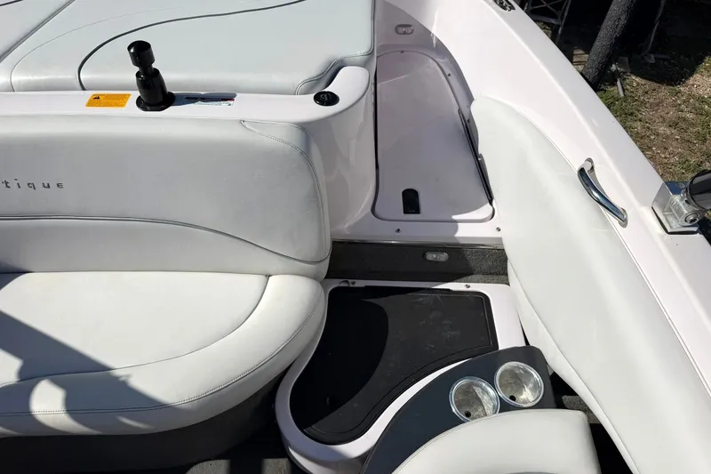 Slide: The Image of Interior of a 2003 Nautique Air Nautique 226 boat, featuring white seating and cup holders. - 28