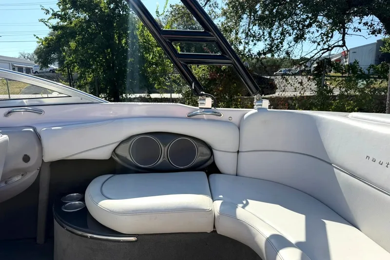 Slide: The Image of 2003 Nautique Air Nautique 226 boat interior with white seating and cup holders. - 29