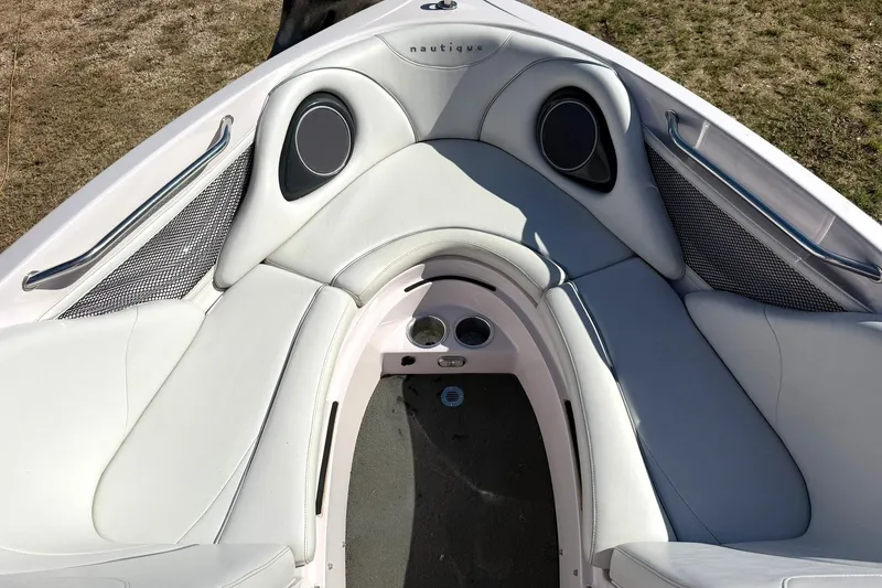 Slide: The Image of 2003 Nautique Air Nautique 226 boat interior with white cushioned seating and speaker system. - 45