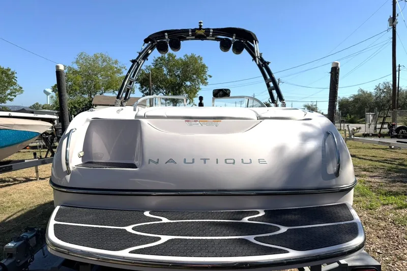 Slide: The Image of 2003 Nautique Air Nautique 226 boat with wakeboard tower, parked outdoors. - 20