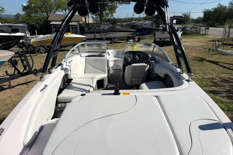 Slide: The Image of 2003 Nautique Air Nautique 226 boat interior with white seating and steering console. - 23