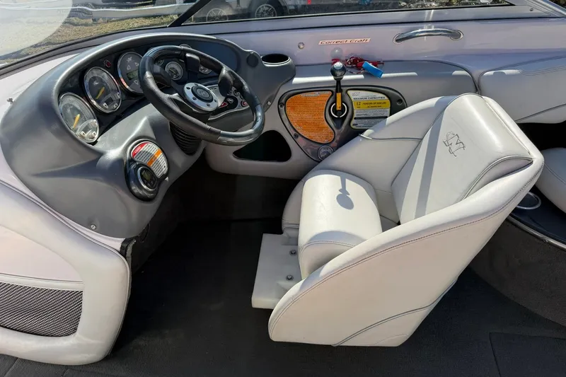 Slide: The Image of 2003 Nautique Air Nautique 226 boat interior with steering wheel and dashboard controls. - 38