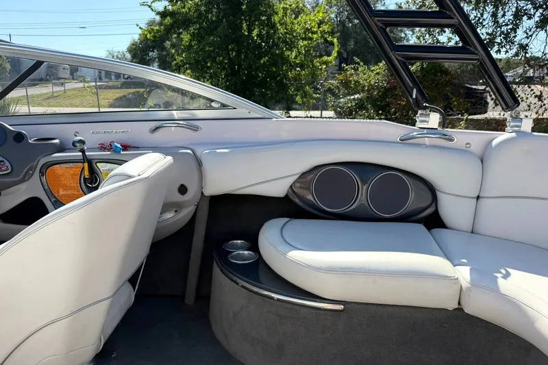Slide: The Image of Interior of a 2003 Nautique Air Nautique 226 boat with white seating and dashboard. - 30