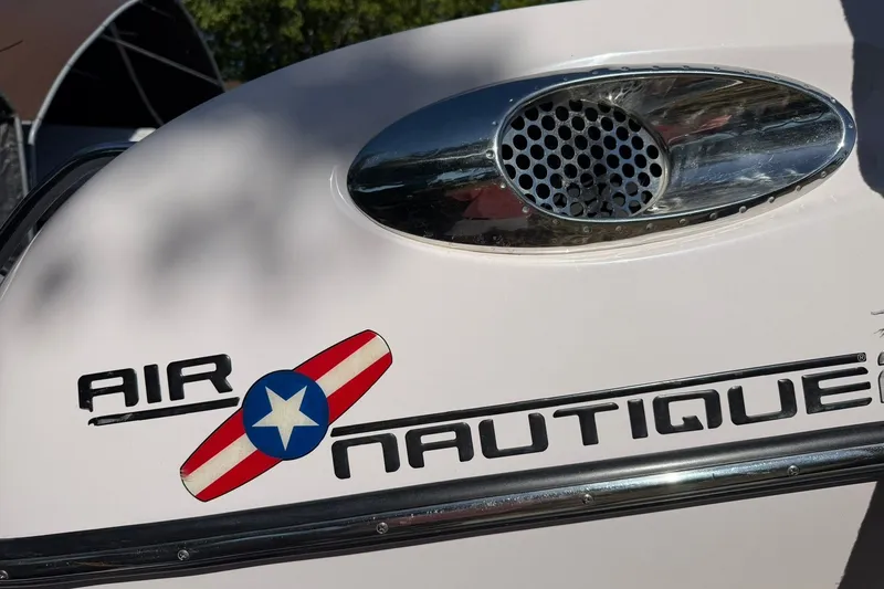 Slide: The Image of 2003 Nautique Air Nautique 226 boat logo with vintage design elements. - 54