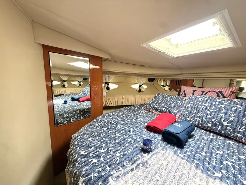 Slide: The Image of Cabin of the 2001 Sea Ray 380 Sundancer with a cozy bed and a skylight. - 45