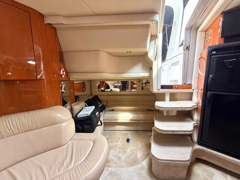 Slide: The Image of Interior of a 2001 Sea Ray 380 Sundancer with beige upholstery and wood accents. - 48
