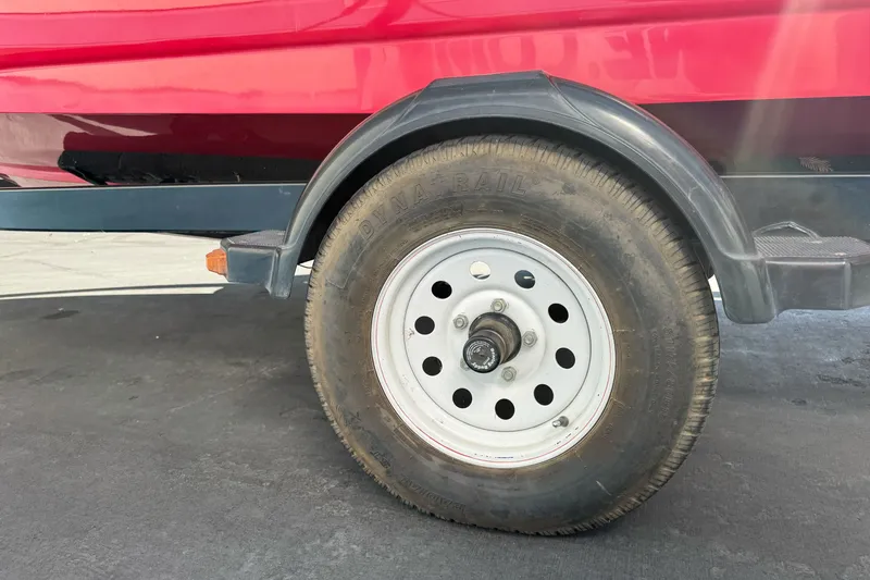 Slide: The Image of Trailer wheel of a 2008 Sea Ray 175 Sport boat, featuring a red hull. - 5