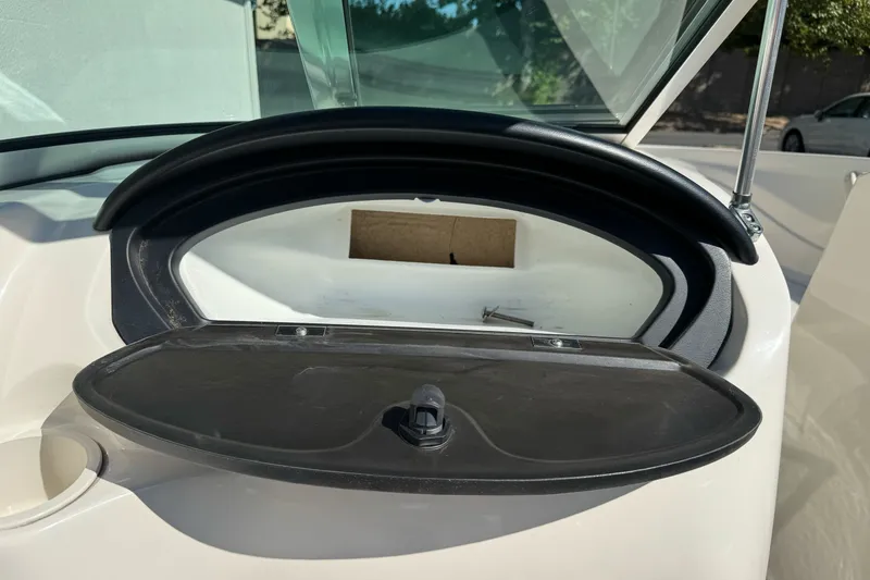 Slide: The Image of Open glove compartment in a 2008 Sea Ray 175 Sport boat, showcasing interior storage. - 13