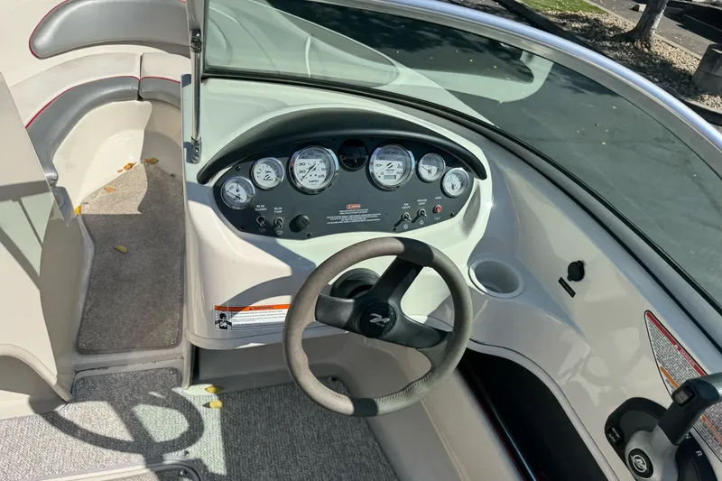 Slide: The Image of 2008 Sea Ray 175 Sport boat dashboard with steering wheel and instrument panel. - 12