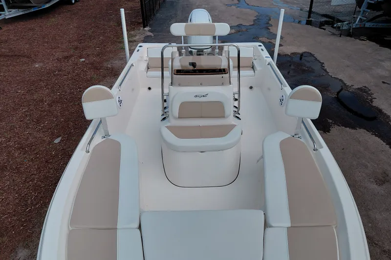 Slide: The Image of 2027 Bulls Bay 2200 XS boat interior with beige seating and steering console. - 14