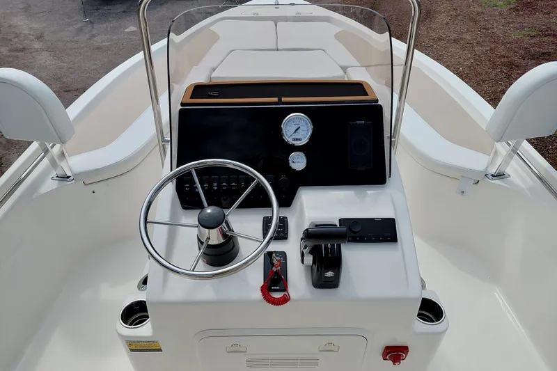 Slide: The Image of 2027 Bulls Bay 2200 XS boat console with steering wheel and controls. - 23