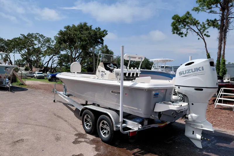 Slide: The Image of 2027 Bulls Bay 2200 XS boat with Suzuki engine on trailer, parked outdoors. - 3