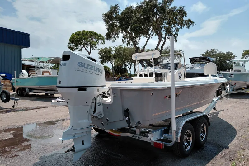 Slide: The Image of 2027 Bulls Bay 2200 XS boat with Suzuki engine on trailer in marina setting. - 5