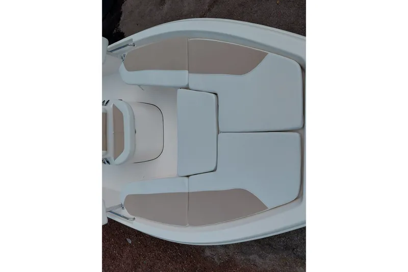 Slide: The Image of 2027 Bulls Bay 2200 XS boat interior with beige and white cushioned seating. - 12