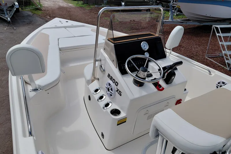 Slide: The Image of 2027 Bulls Bay 2200 XS boat interior with steering console and seating. - 21