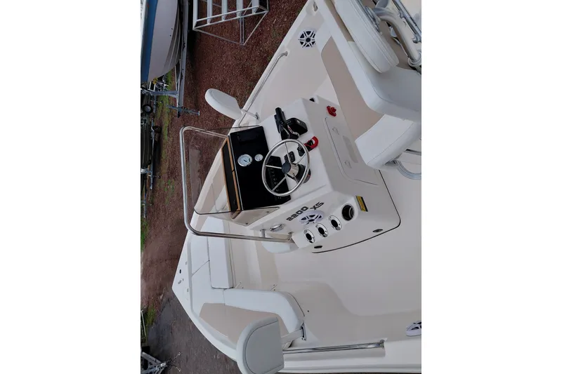 Slide: The Image of 2027 Bulls Bay 2200 XS boat interior with steering console and seating. - 32