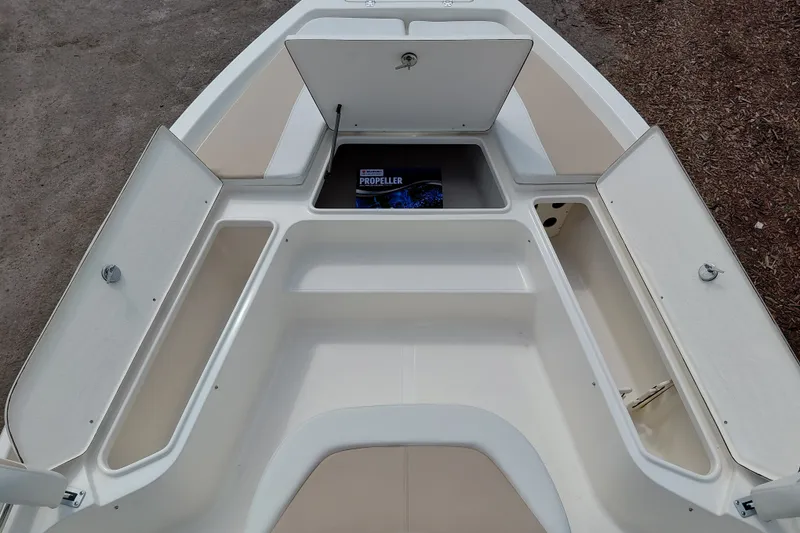 Slide: The Image of 2027 Bulls Bay 2200 XS boat storage compartments open, showcasing spacious interior design. - 19
