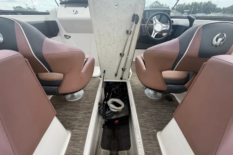 Slide: The Image of Interior of a 2018 Scarab 255 ID boat with brown seats and storage compartment. - 21