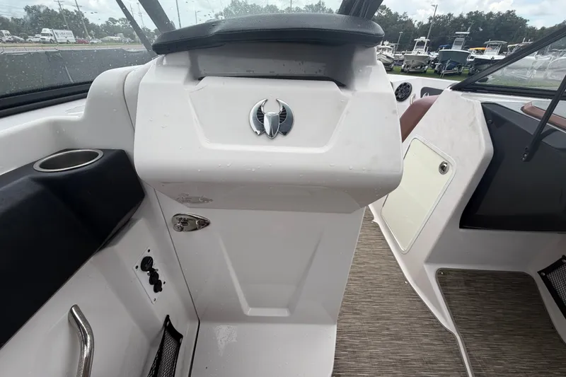 Slide: The Image of 2018 Scarab 255 ID boat interior with steering console and cup holder. - 32