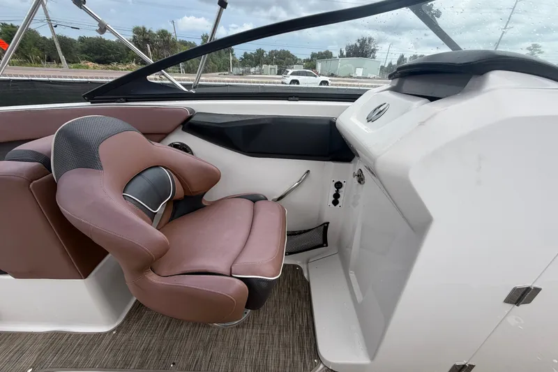 Slide: The Image of Interior of 2018 Scarab 255 ID boat with brown seating and modern dashboard. - 31