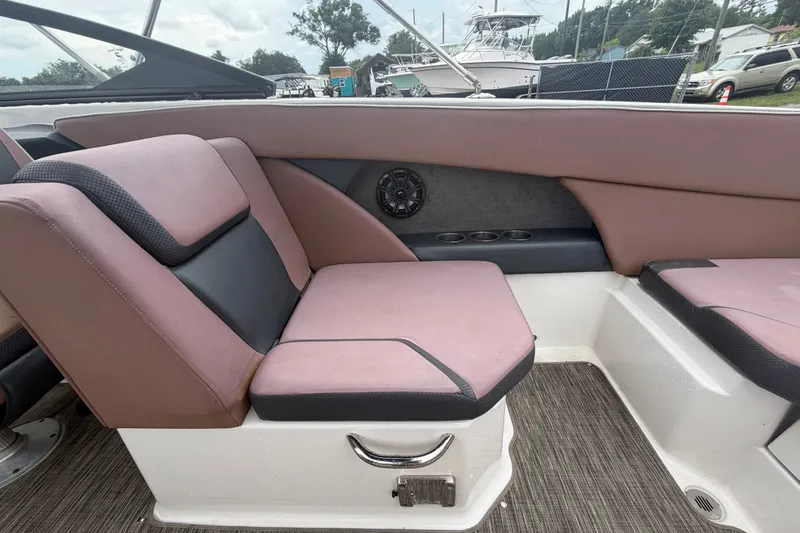 Slide: The Image of 2018 Scarab 255 ID boat interior with pink and black seating, cup holders, and speaker. - 16