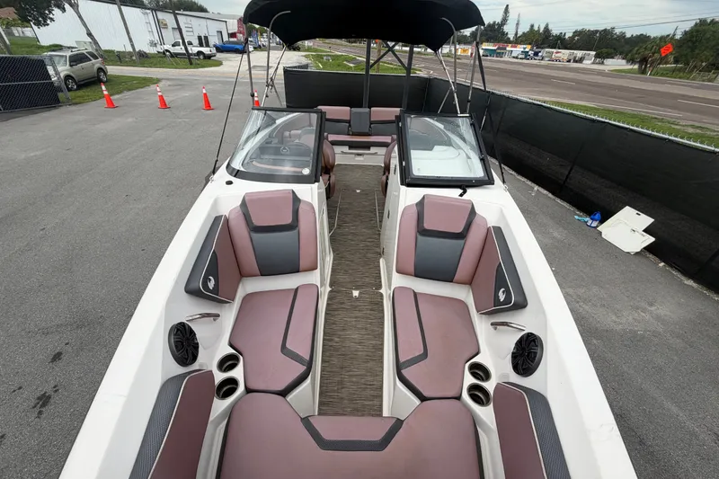 Slide: The Image of 2018 Scarab 255 ID boat with spacious seating and modern design in a parking area. - 50
