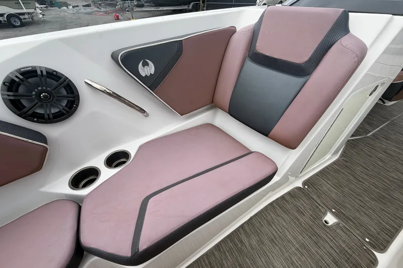 Slide: The Image of 2018 Scarab 255 ID boat interior with cushioned seating, speaker, and cup holders. - 48