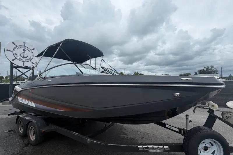 The Image of 2018 Scarab 255 ID boat on trailer under cloudy sky. - 0