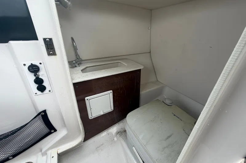 Slide: The Image of Compact bathroom in 2018 Scarab 255 ID boat with sink and portable toilet. - 34