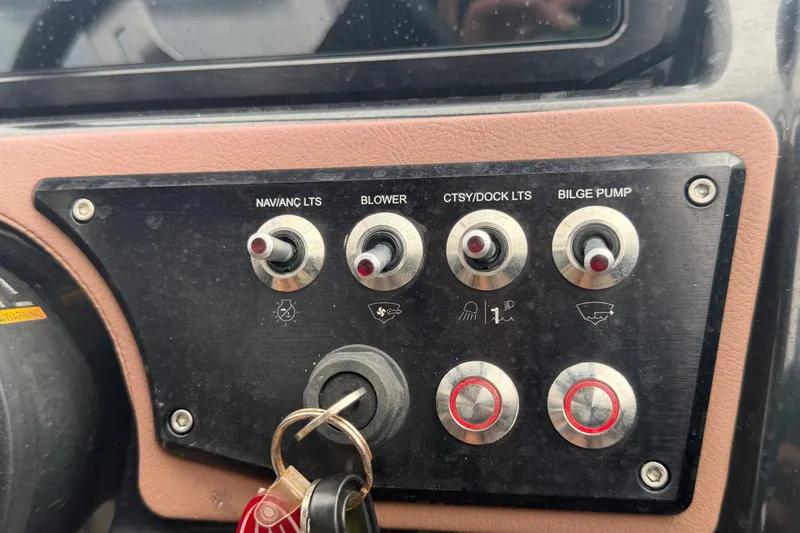 Slide: The Image of Control panel of a 2018 Scarab 255 ID boat with labeled switches and keys. - 27