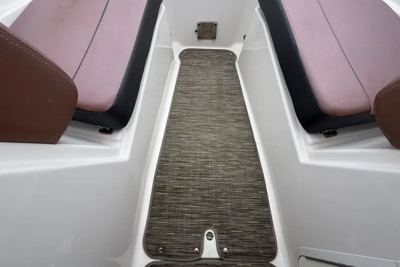 Slide: The Image of Interior of 2018 Scarab 255 ID boat with brown seating and textured flooring. - 39
