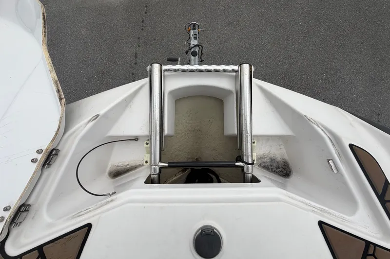 Slide: The Image of Bow view of a 2018 Scarab 255 ID with anchor locker and bow ladder. - 47